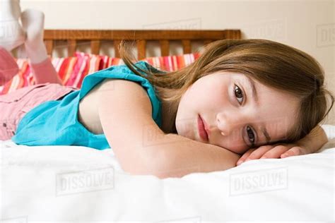 Girl Lying On Bed Stock Photo Dissolve