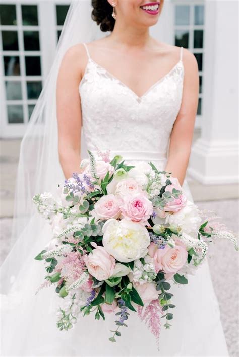 This vibrant bouquet, designed by poppies and posies, featured peach ranunculus, white garden roses, coral charm peonies, violet cosmos, white andromeda, maidenhair fern, and white. Large loose bridal bouquet of rose, peonies and eucalyptus ...