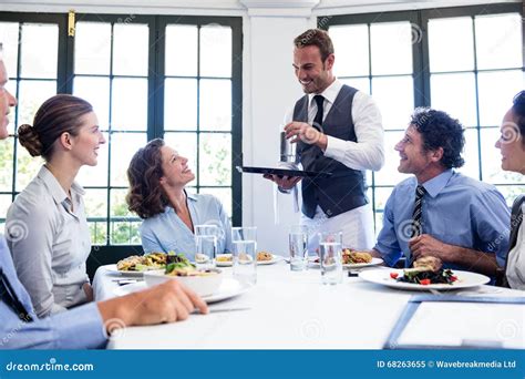 Waiter Serving Water To Business People Stock Image Image Of Elegance