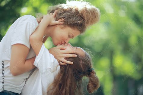 Daughter Kisses Mom Happy Family Mom And Daughter Kiss Concept Of Female Happiness Beautiful