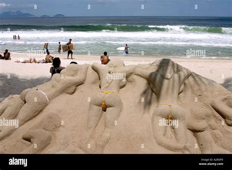 Sand Sculpture Of Women In Bikinis Sunbathing Copacabana Beach Rio De Janeiro Brazil Stock Photo