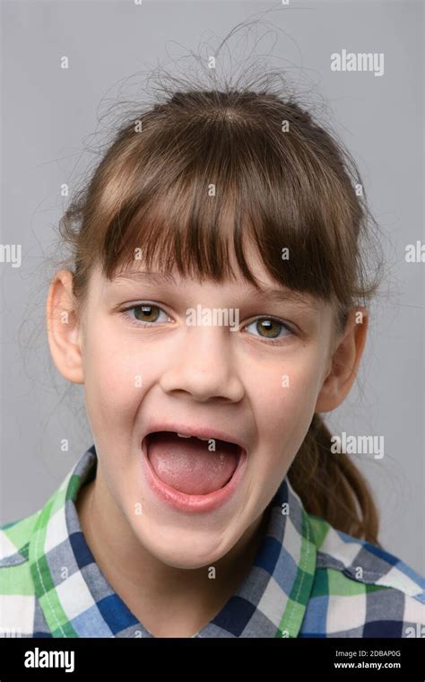 Portrait Of A Happy Ten Year Old Girl With Wide Mouth European