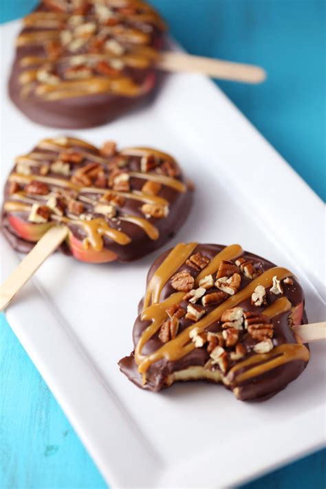 Chocolate turtle apple slices are thick slices of fuji apples covered in melted chocolate, drizzled with caramel and topped with nuts. CHOCOLATE TURTLE APPLE SLICES | NEW FOOD RECIPES