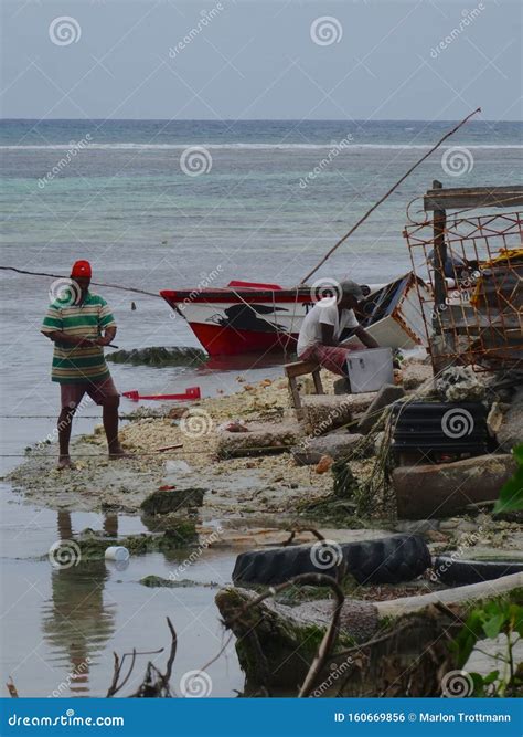 Jamaican Fishermen In Traditional Boats At Blue Lagoon Jamaica