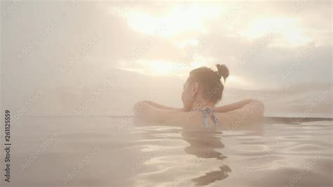 Back View Of Beautiful Naked Woman Bathing And Relaxing In Hot Springs