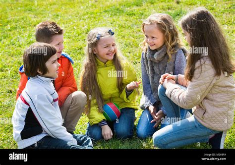 Grupo De Niños Felices Riendo Y Conversando En La Primavera Park