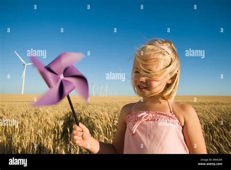Girl Holding Pinwheel On Wind Farm Stock Photo Alamy