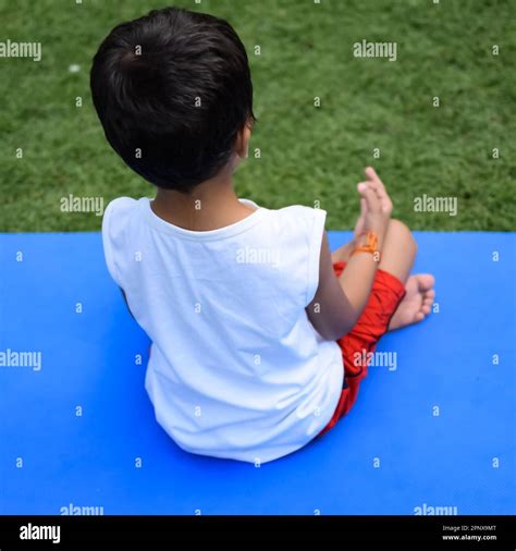 Asian Smart Kid Doing Yoga Pose In The Society Park Outdoor Childrens