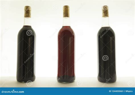 Three Bottles Of Red Wine With Different Tones Stock Photo Image Of