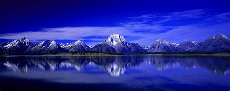 A Lake With Mountains In The Background And A Bible Verse About Gods Word