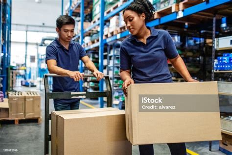 Workers Moving Boxes In Warehouse Stock Photo Download Image Now
