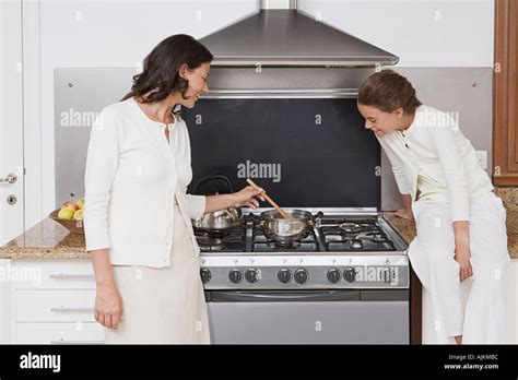 Mother And Daughter Cooking Stock Photo Alamy