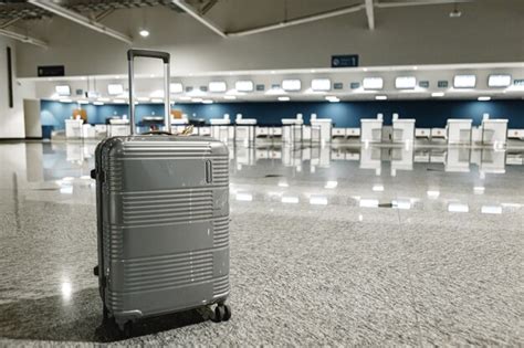 Premium Photo Gray Travel Suitcase In Empty Airport Hall