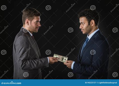 Businessman Giving Money And Bribing Business Partner Stock Image