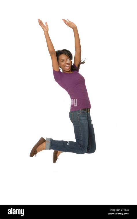 Happy Teenage Girl Jumping In The Air On White Background Stock Photo