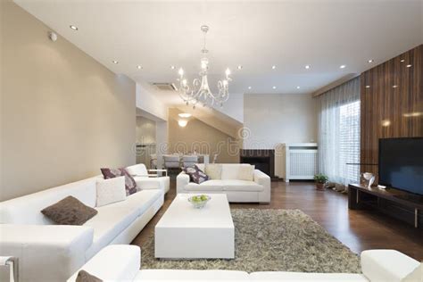 Interior Of A Spacious Living Room With Fireplace In Luxury Apartment