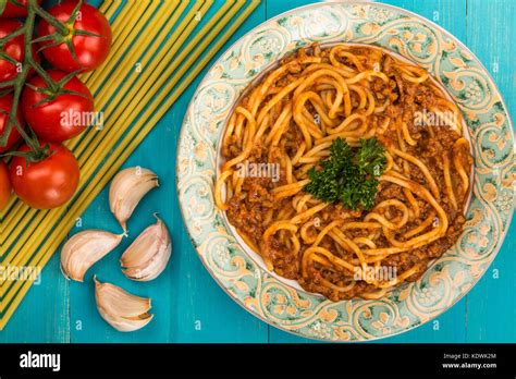 Italian Style Spaghetti Bolognese Meal With A Rich Beef Sauce On A Blue Wooden Background Stock