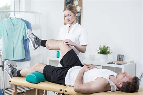 Chiropractor Exercising Mans Leg Advanced Health Solutions Woodstock