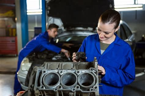Free Photo Female Mechanic Working On Engine