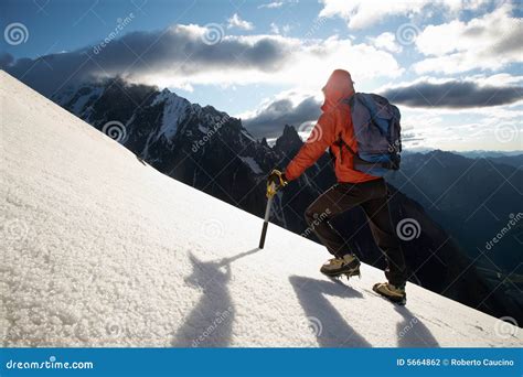 Mountain Climber On Snowy Slope With Safety Line Attached Royalty Free