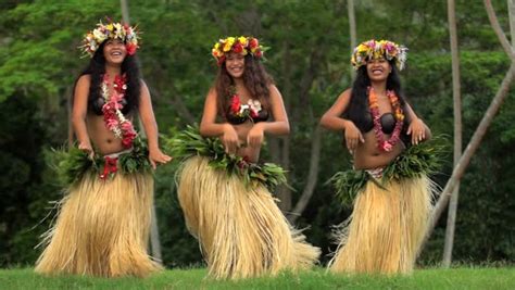 Barefoot Tahitian Women In Hula Skirts And Flower Headdress Performing