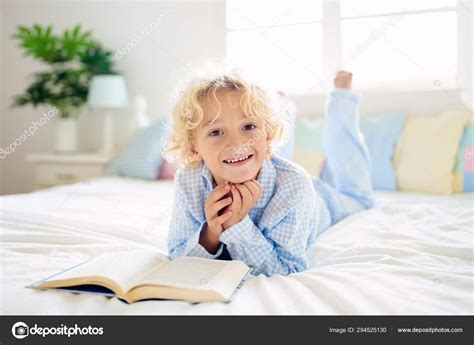 Child Reading Book In Bed Kids Read In Bedroom Stock Photo By