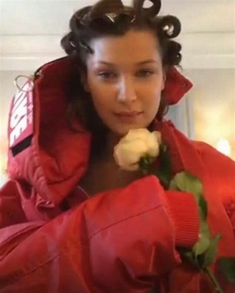 A Woman In A Red Jacket Holding A Rose