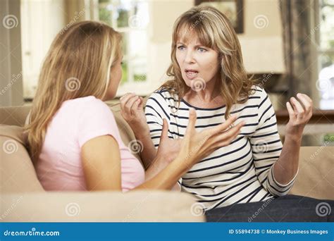 Mother And Teenage Daughter Arguing On Sofa At Home Stock Photo Image