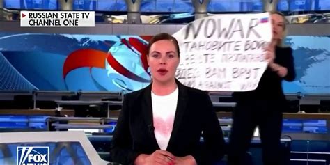 protester interrupts russian state tv to display anti war message fox news video