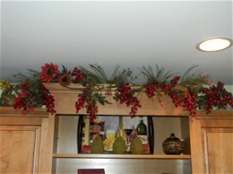 My excitement started with christmas garland that i bought last year. Decorating Above Kitchen Cabinets- Before and After Pictures and Tips - JOYFUL DAISY