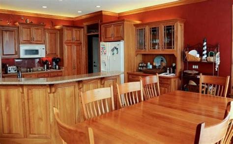 Here, a burnt orange accent chair and sculptural orange table lamps mingle with rich, verdant greens. burnt orange kitchen - Google Search | Orange kitchen ...