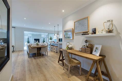 An Open Concept Living And Dining Room With Wood Floors White Walls