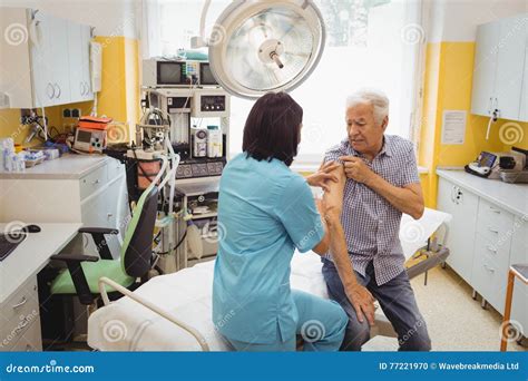 Female Doctor Giving An Injection To A Patient Stock Photo Image Of