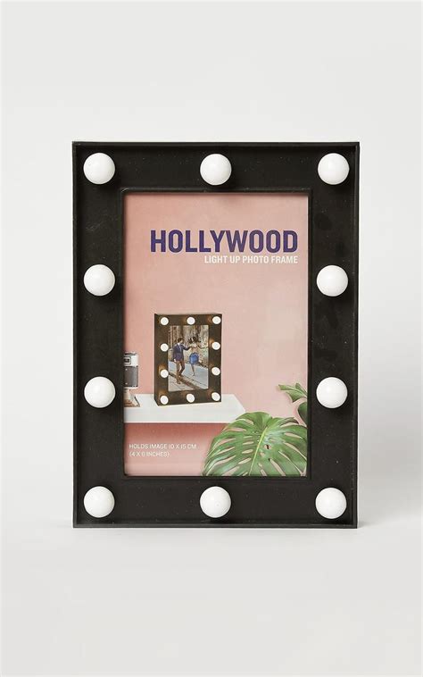 The Hollywood Light Up Photo Frame Is Black With White Polka Dots And
