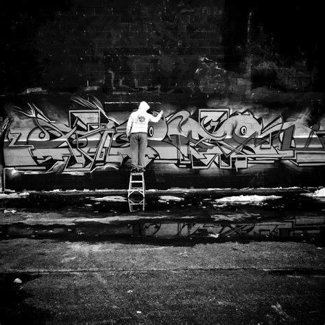 Grayscale Photo Of Person Doing Graffiti · Free Stock Photo