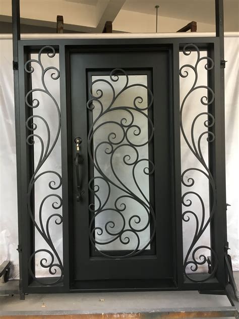 A Black Door With Intricate Iron Work On The Front And Side Doors