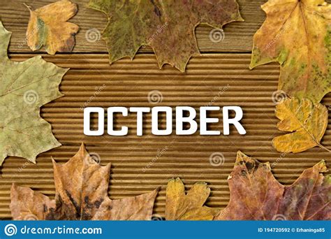 October Word Letters With Autumn Dried Leaves Over Wooden Background