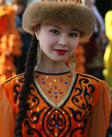 A Woman In An Orange Dress And Fur Hat