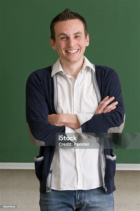 Teacher With Arms Crossed At Blackboard Stock Photo Download Image