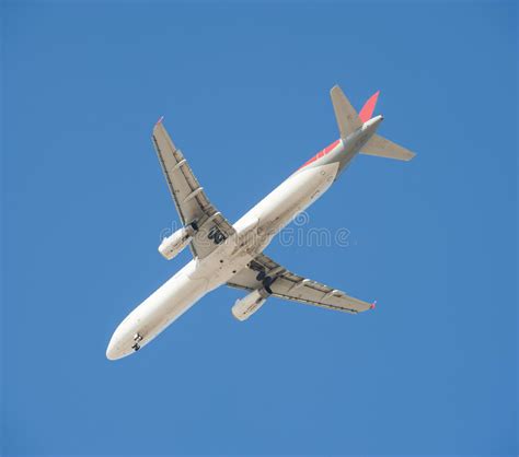 Large Passenger Aircraft In Flight Against Blue Sky Stock Photo Image