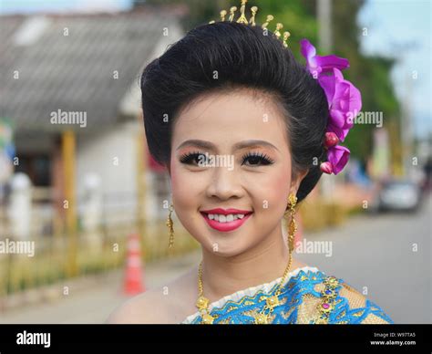 Dressed Up Pretty Thai Girl With Flowers In Her Hair Takes Part In The Village S Historical