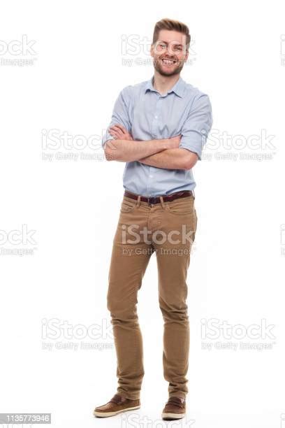 Full Length Portrait Of Young Man Standing On White Background Stock