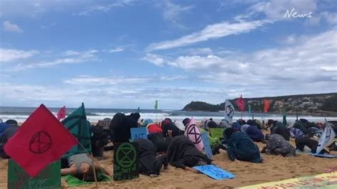 Extinction Rebellion Protesters Bury Their Heads In The Sand On Manly