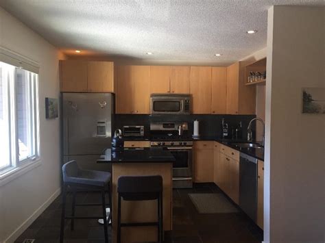 Fully insured and referrals provided. Maple kitchen cabinets and island with black granite ...
