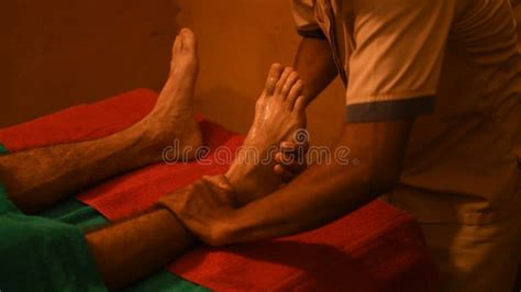 Man Having Ayurveda Healing Therapy For Foot Relaxation Massage Stock