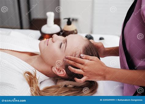 Asian Massage Therapist Woman Is Making Traditional Head And Facial Treatment Massage To