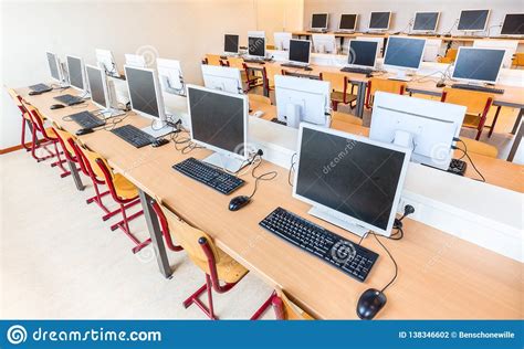 Computer Class With Rows Of Desktop Computers In School Stock Photo