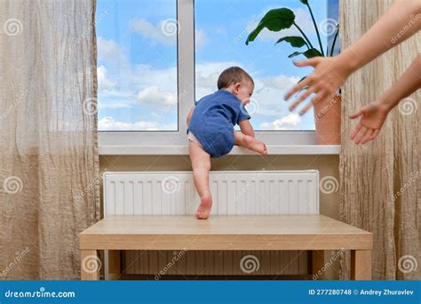 Toddler Baby Climbs To The Window And The Hands Of A Frightened Moth