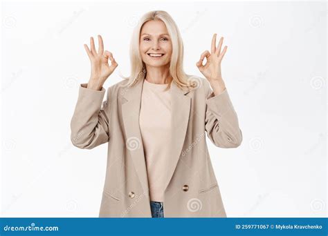 happy smiling older woman 50 years old mature female model shows okay ok sign in approval