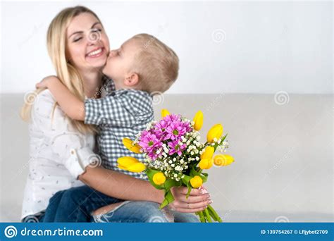 Son Gives His Beloved Mother A Beautiful Bouquet Of Tulipsthe Concept